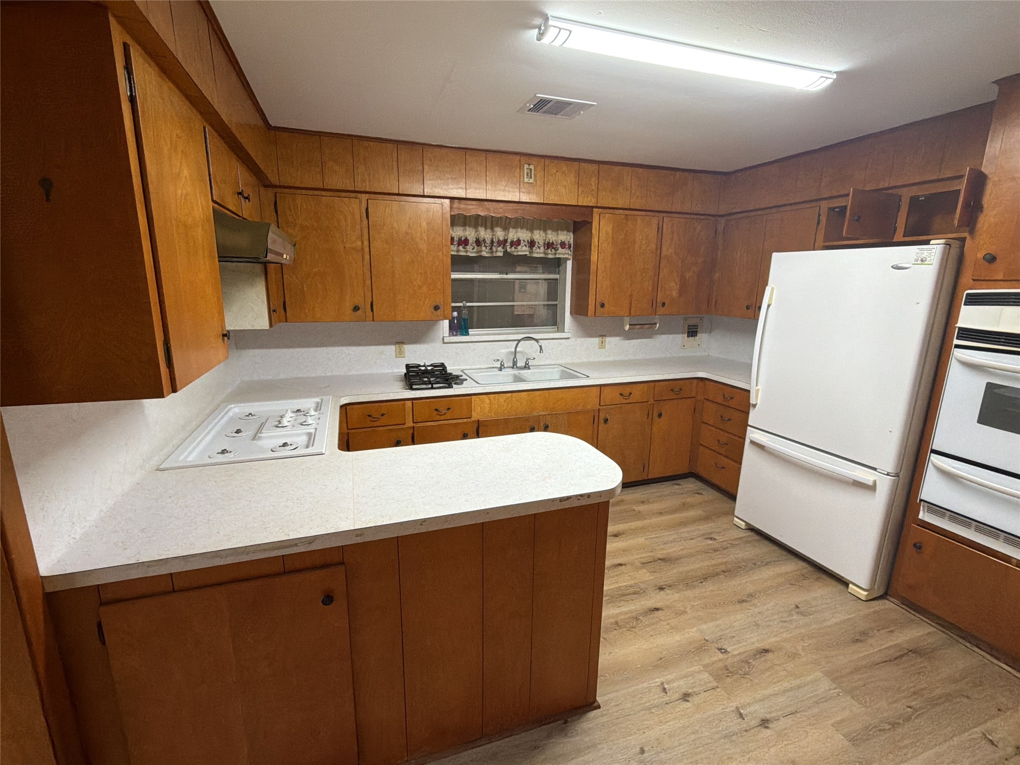 3604 Rychlik Drive Rosenberg, TX 77471 - Photo 7 of 13 a kitchen with a sink a refrigerator and wooden floor