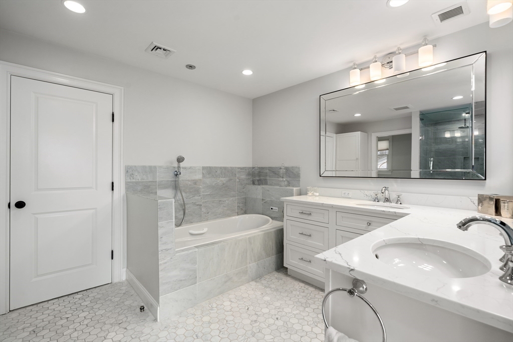 96 Oldham Road Newton, MA 02465 - Photo 14 of 40 a bathroom with a sink a toilet a mirror and bathtub