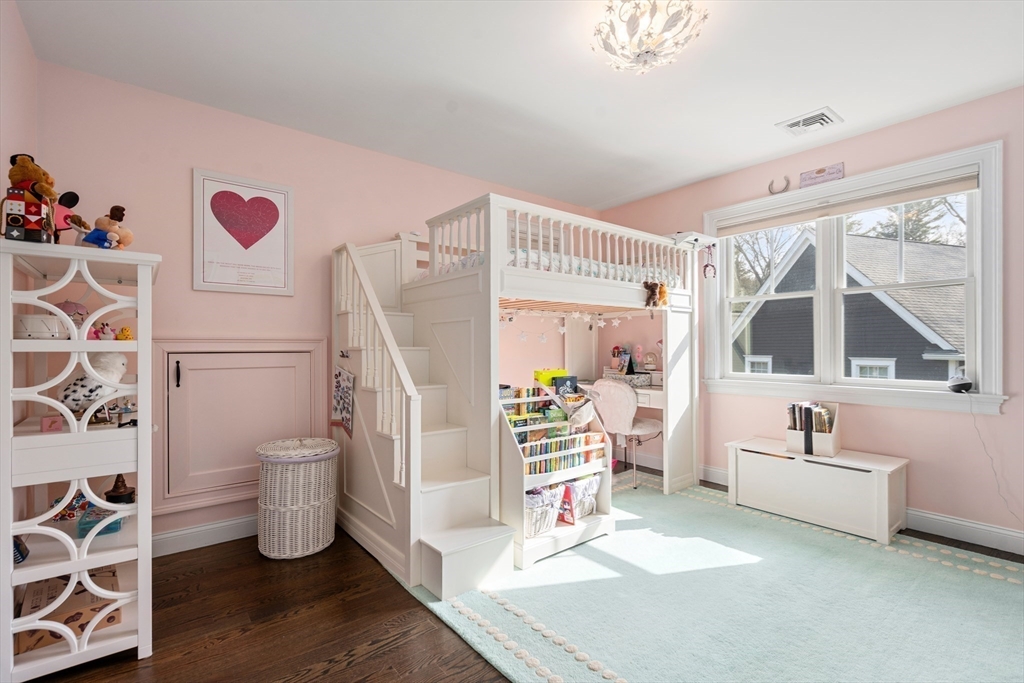 96 Oldham Road Newton, MA 02465 - Photo 19 of 40 a living room with a couch and a large window with wooden floor
