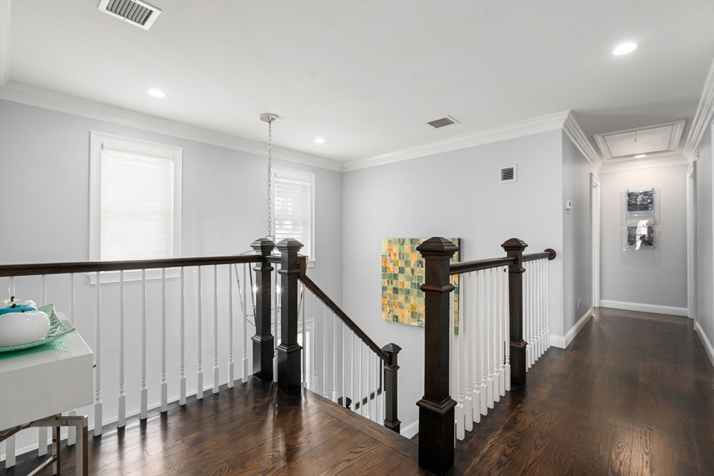 96 Oldham Road Newton, MA 02465 - Photo 22 of 40 a view of a hallway with wooden floor and stairs
