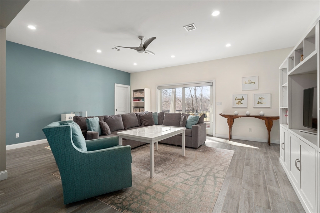 96 Oldham Road Newton, MA 02465 - Photo 23 of 40 a living room with furniture a flat screen tv and a fireplace