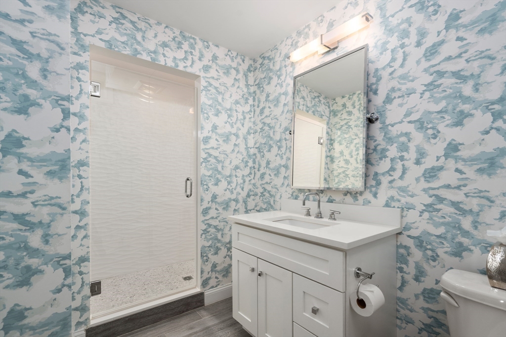 96 Oldham Road Newton, MA 02465 - Photo 26 of 40 a bathroom with a sink a toilet and shower