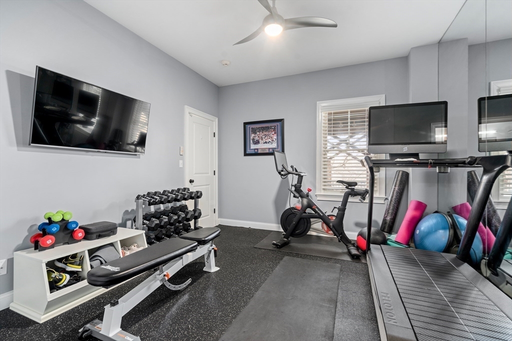 96 Oldham Road Newton, MA 02465 - Photo 27 of 40 a living room with furniture and a flat screen tv