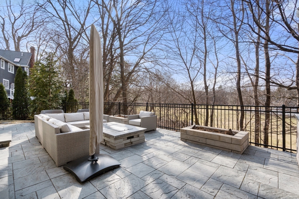 96 Oldham Road Newton, MA 02465 - Photo 32 of 40 a view of couches in the patio with a fire pit