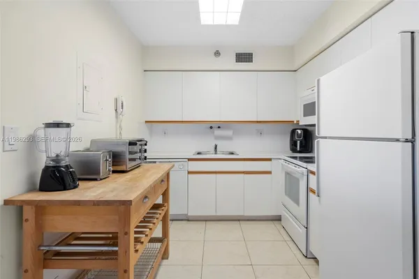 a kitchen with a sink a stove and a refrigerator