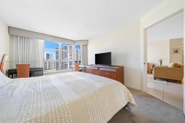 a bedroom with a bed and a television