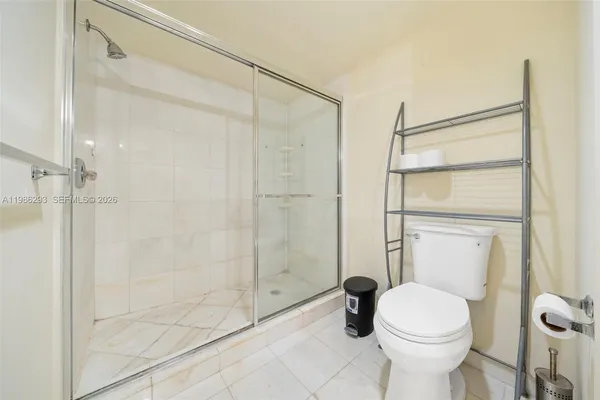 a bathroom with a toilet and shower