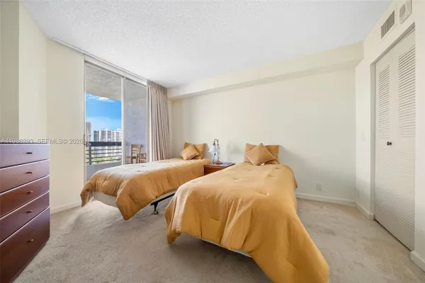 a bedroom with two beds and painting on the wall