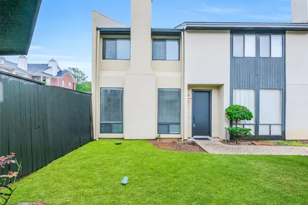 a view of a backyard with potted plants and a chair