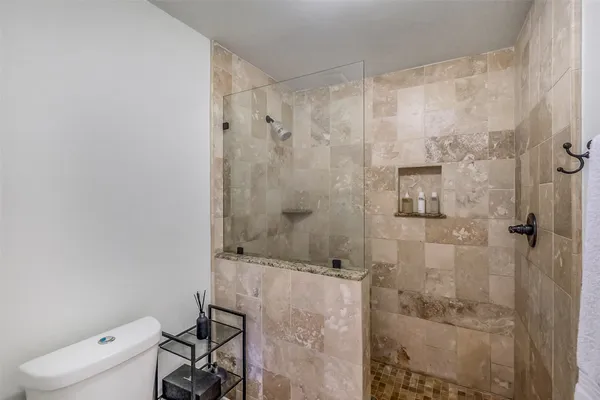 a bathroom with a shower toilet and sink