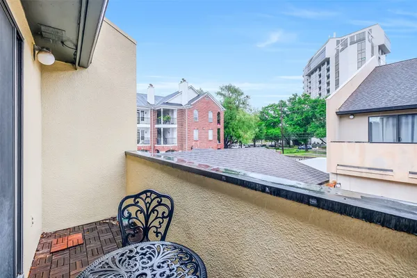 a balcony with a table and chairs