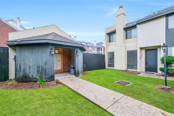 a front view of a house with a garden and yard