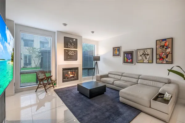 a living room with furniture fireplace and flat screen tv