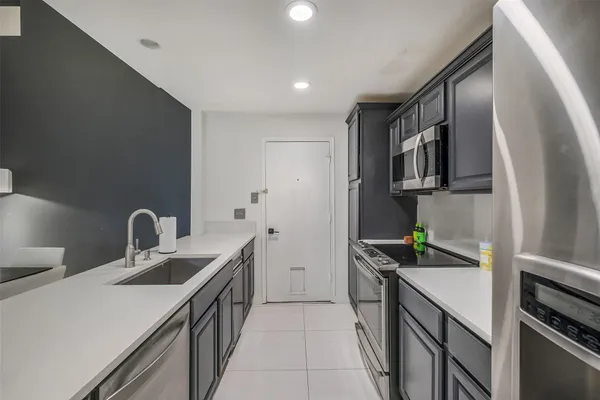 a kitchen that has a sink and a stove