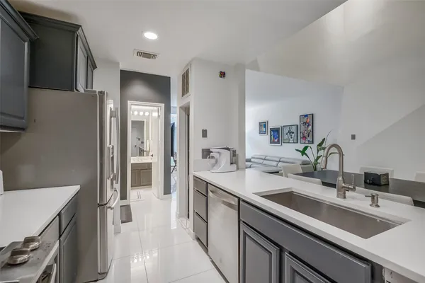 a kitchen with a sink stove and refrigerator