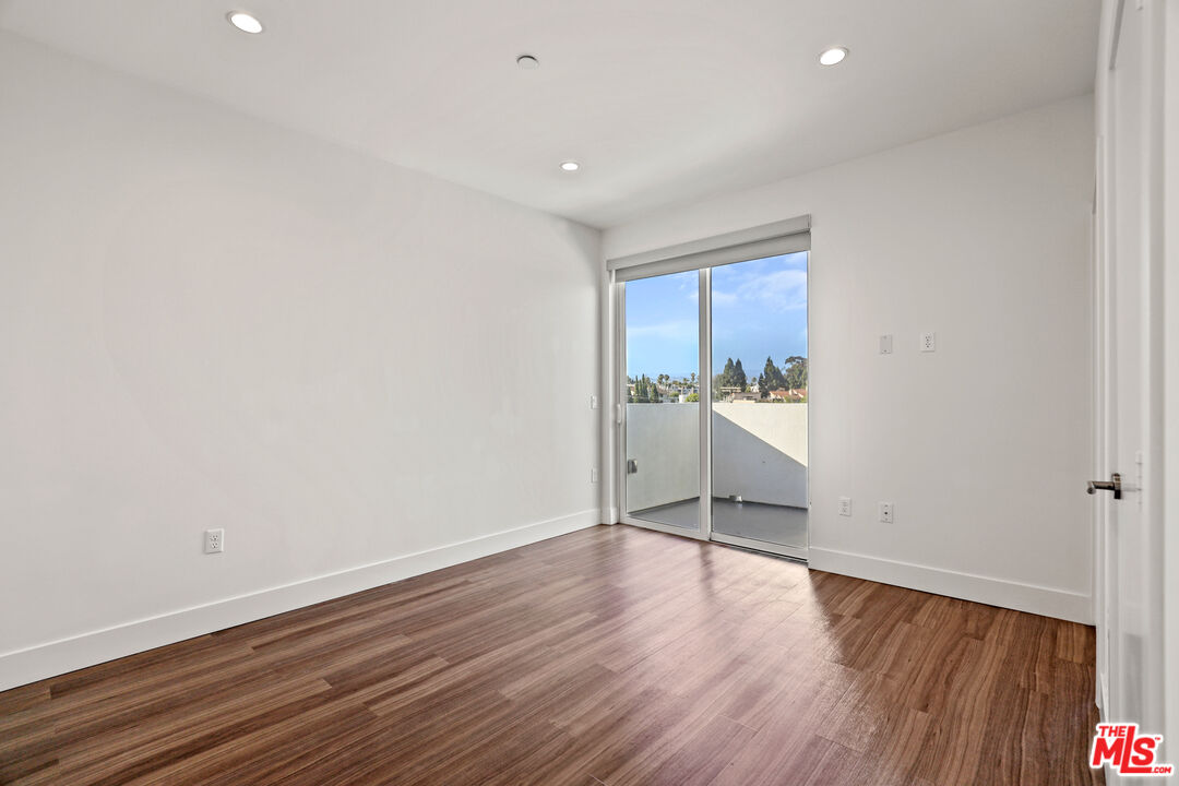 3618 Dunn Drive, Unit 304 Los Angeles, CA 90034 - Photo 11 of 13 a view of a room with wooden floor and window