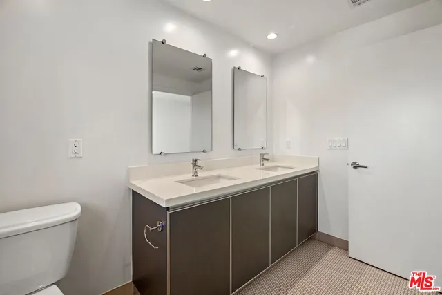 a bathroom with a sink toilet and mirror