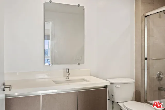 a bathroom with a sink toilet and a mirror