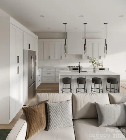 a living room with stainless steel appliances kitchen island granite countertop furniture and a view of kitchen