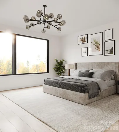 a spacious bedroom with a large bed and a chandelier