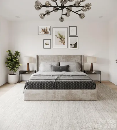 a bedroom with a large bed and a chandelier