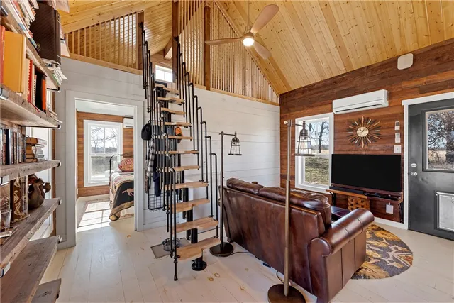a view of a livingroom with workspace and a window