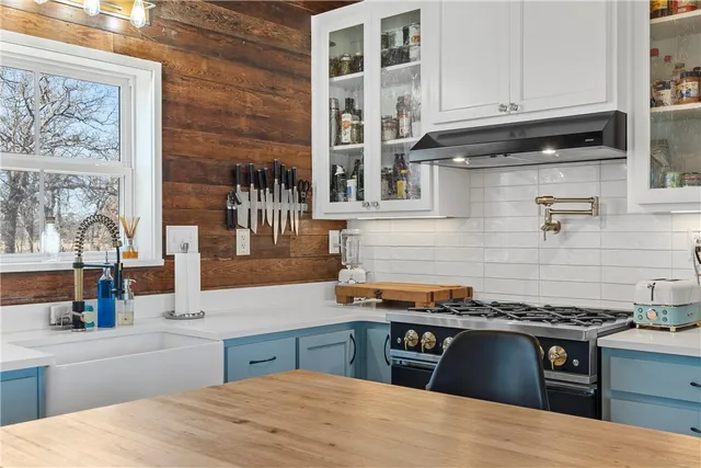 a kitchen with stainless steel appliances granite countertop a stove and a sink