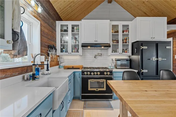 a kitchen with stainless steel appliances granite countertop a stove and a sink