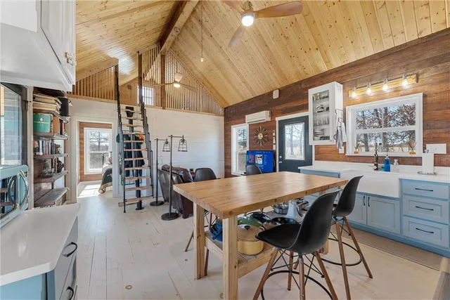 a dining hall with stainless steel appliances granite countertop a stove a sink and a refrigerator