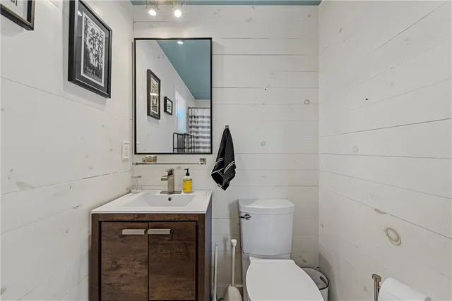 a bathroom with a toilet sink and mirror