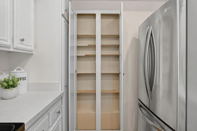 a kitchen with a refrigerator and cabinets