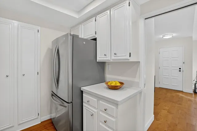 a view of walk in closet with white walls and entryway