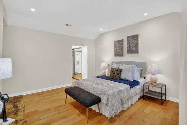 a bedroom with a bed and a lamp