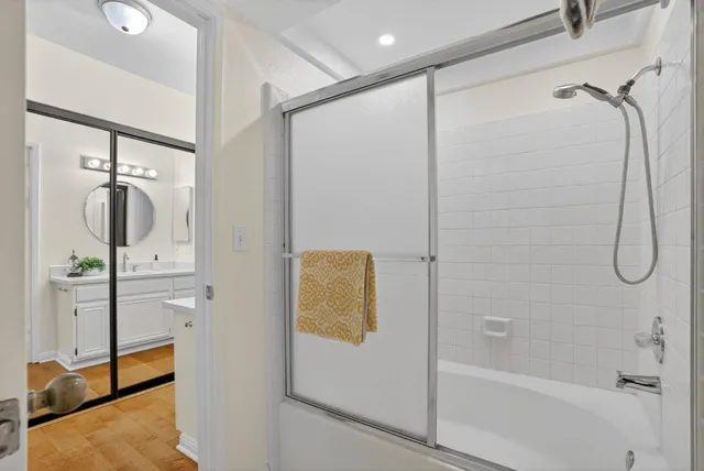 a bathroom with a granite countertop toilet and a sink