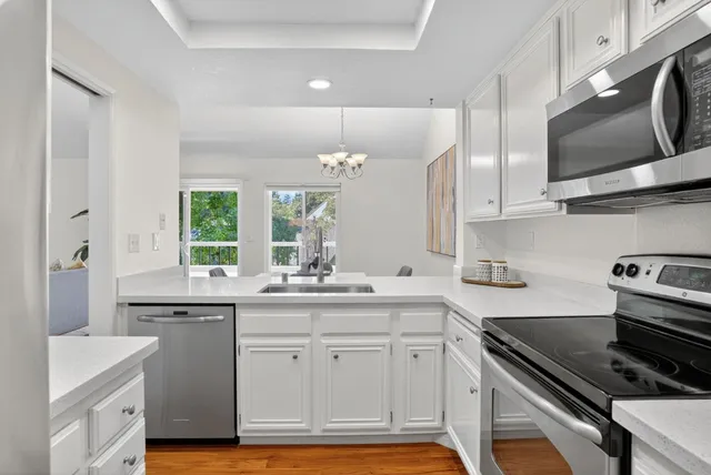 a kitchen with a sink stove and microwave