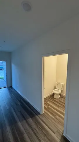 a view of a room with wooden floor and cabinet