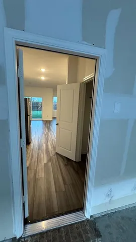a kitchen with sink cabinets and wooden floor