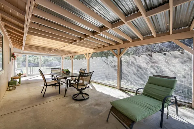 a view of a backyard with table and chairs