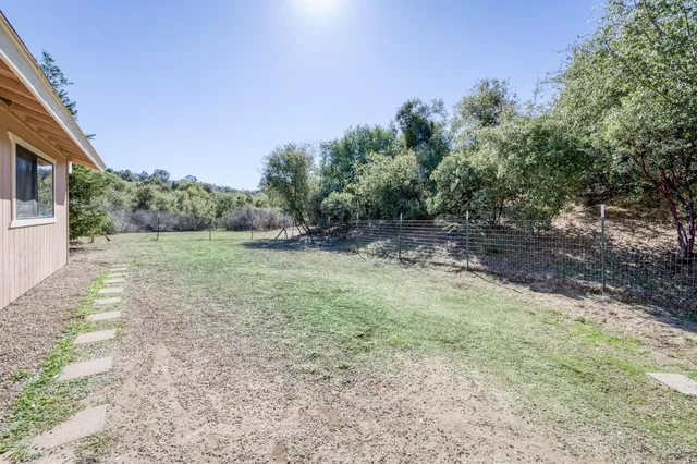 a view of a field with trees in the background