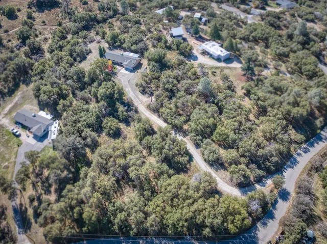 an aerial view of house with yard and outdoor seating