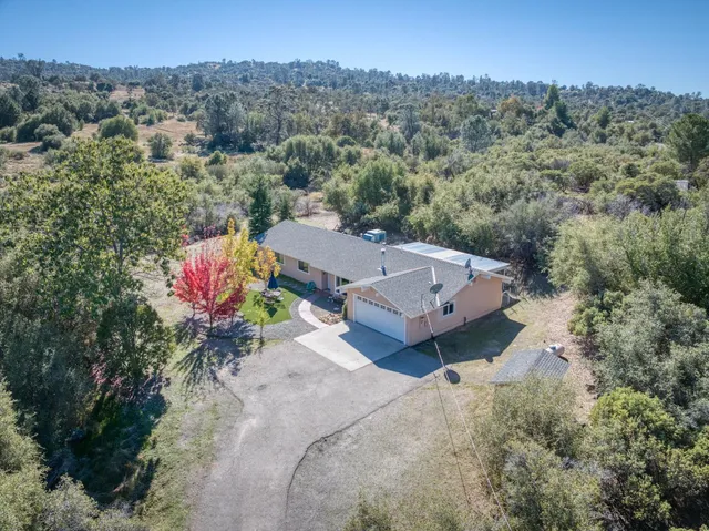 an aerial view of a house with a garden