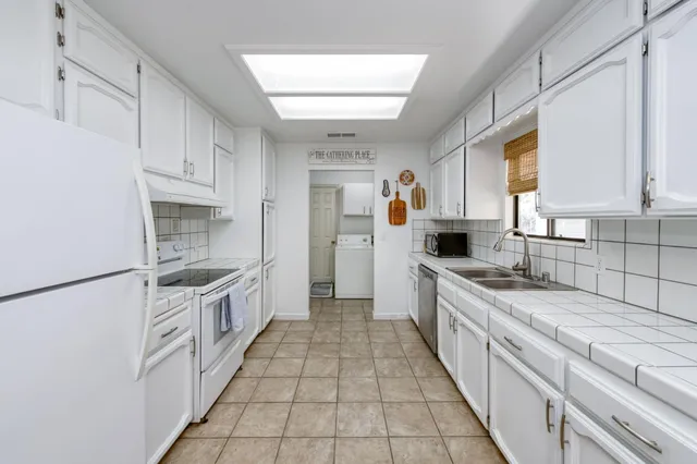 a large kitchen with a stove top oven