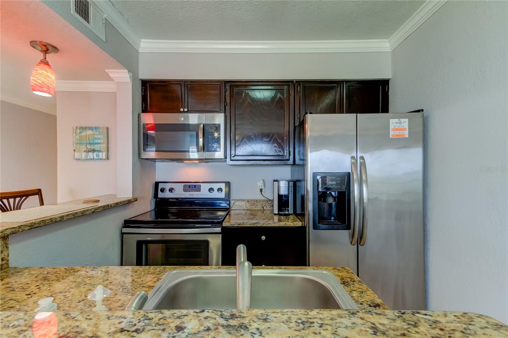 2506 North Rocky Point Drive, Unit 457 Tampa, FL 33607 - Photo 2 of 24 a kitchen with a refrigerator and a sink