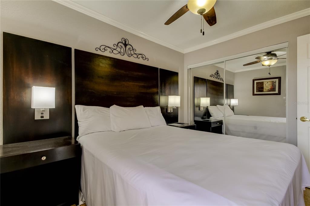 2506 North Rocky Point Drive, Unit 457 Tampa, FL 33607 - Photo 6 of 24 a bedroom with a bed and a flat tv screen