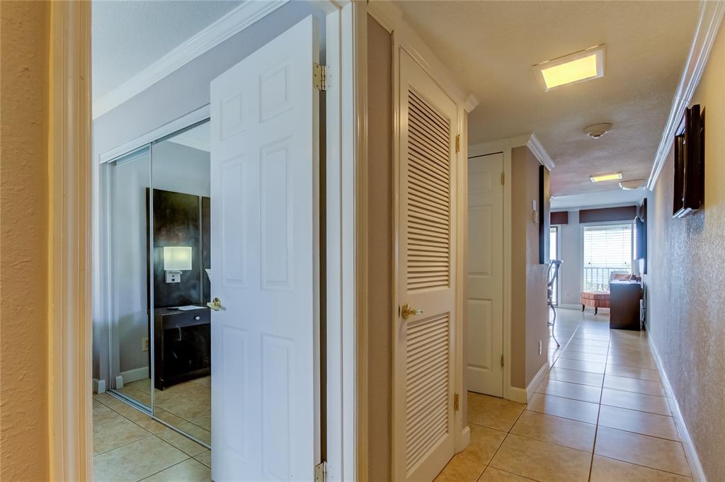 2506 North Rocky Point Drive, Unit 457 Tampa, FL 33607 - Photo 7 of 24 a view of a hallway with some storage and a bathroom