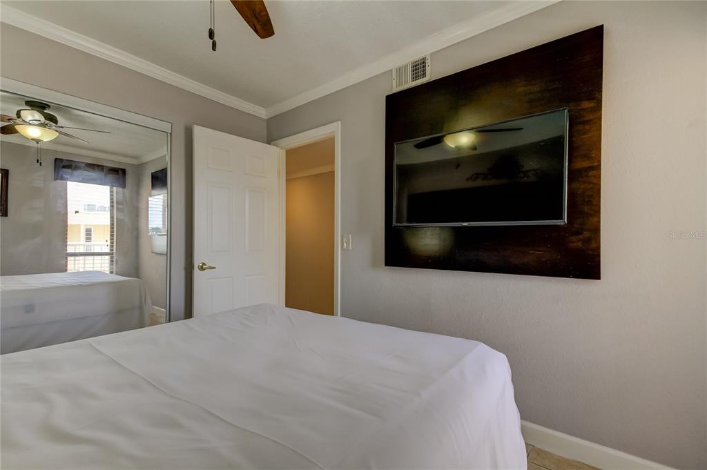 2506 North Rocky Point Drive, Unit 457 Tampa, FL 33607 - Photo 8 of 24 a bedroom with a bed and a television