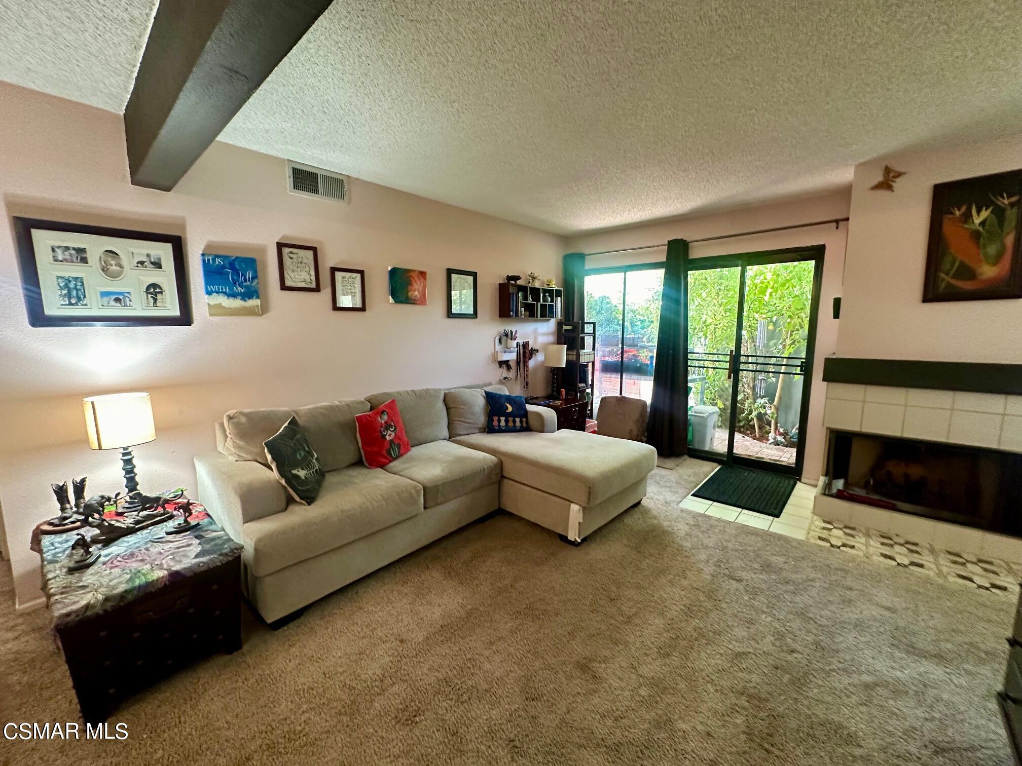 2506 Chandler Avenue, Unit 255 Simi Valley, CA 93065 - Photo 3 of 5 a living room with furniture and a fireplace