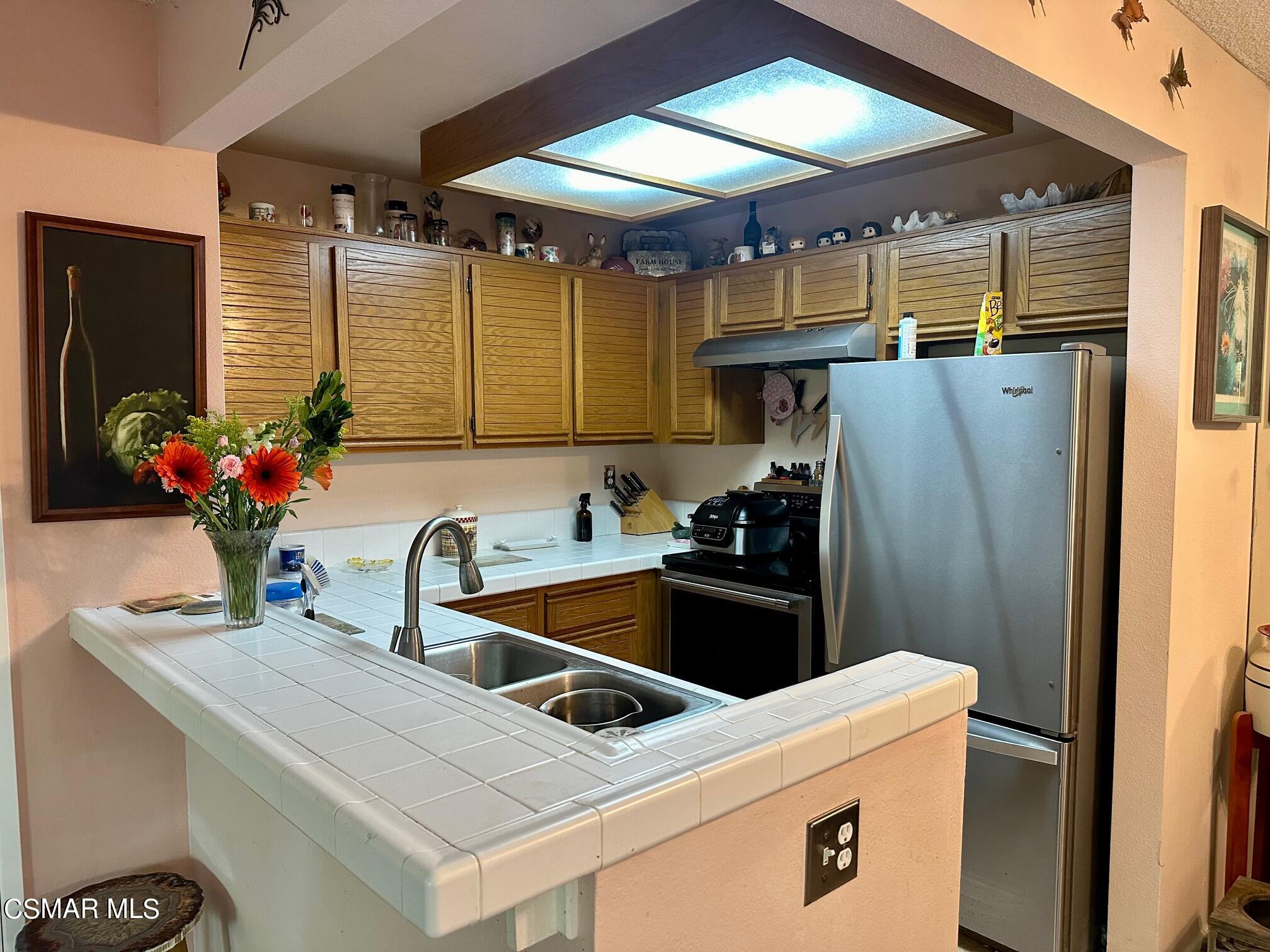 2506 Chandler Avenue, Unit 255 Simi Valley, CA 93065 - Photo 4 of 5 a kitchen with stainless steel appliances kitchen island granite countertop a refrigerator and a sink