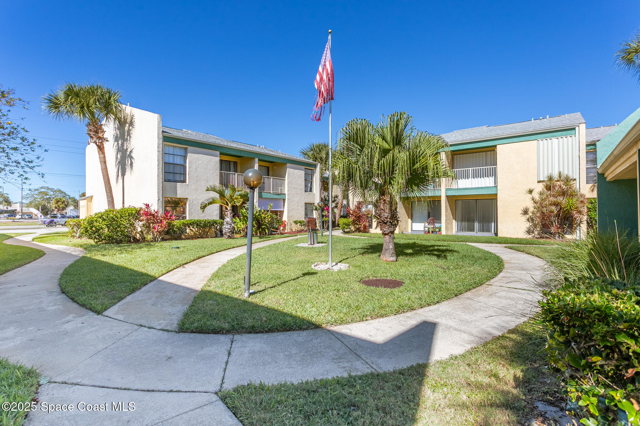 1225 North Wickham Road, Unit 712 Melbourne, FL 32935 - Photo 1 of 24 a front view of a house with garden