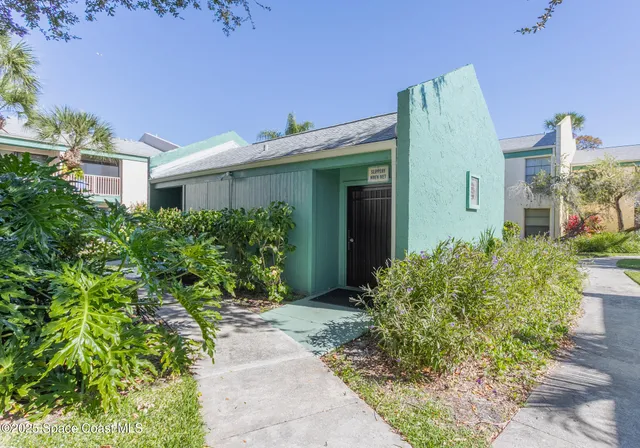 a view of a house with a yard and plants